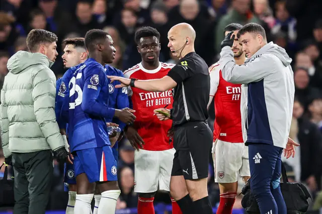 Moisés Caicedo of Chelsea with Referee Anthony Taylor
