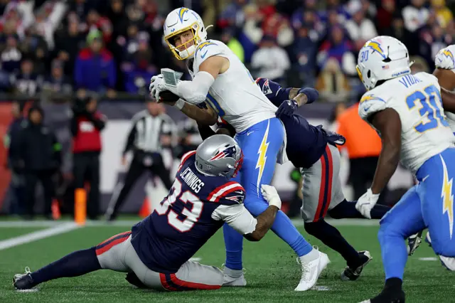 Justin Herbert is sacked by two Patriots defenders