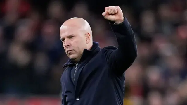 Slot punches the air in front of the fans