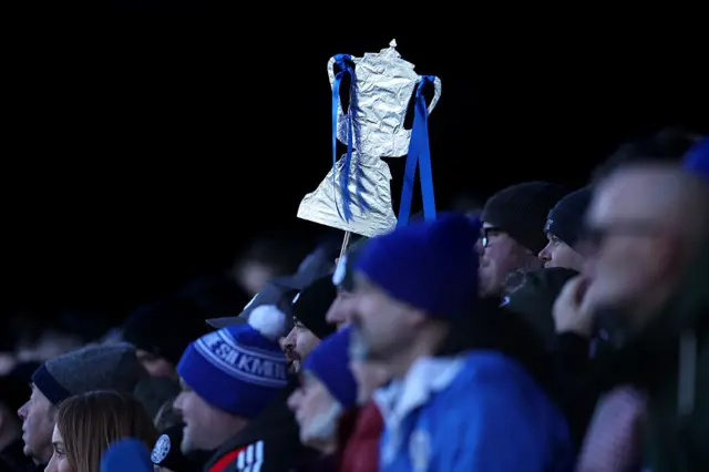 Tinfoil FA Cup held up in the stands