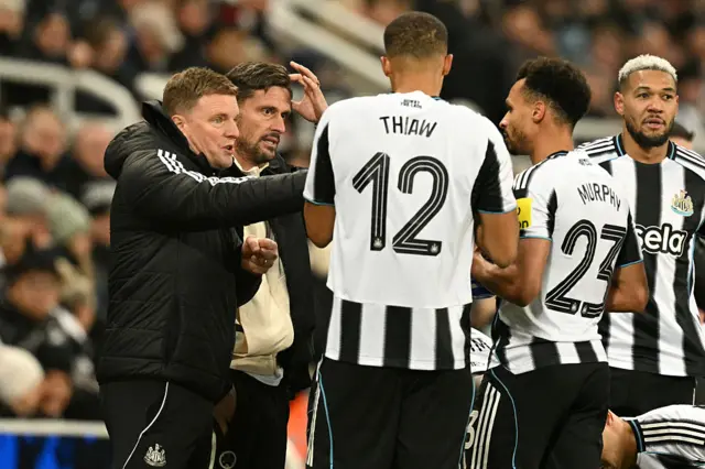 Newcastle United's English head coach Eddie Howe speaks to his players