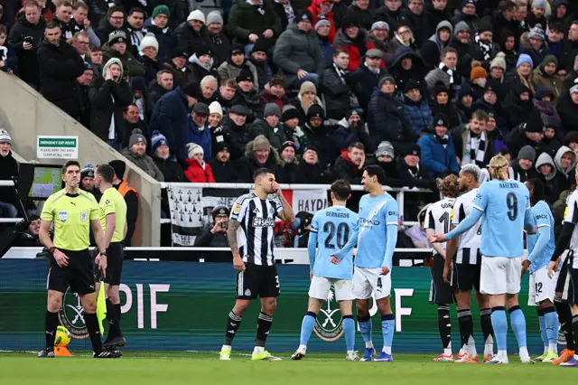 Referee Chris Kavanagh checks the VAR screen