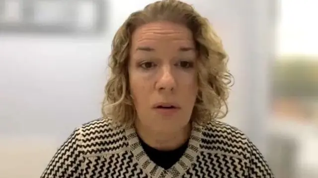 Nicola Higgins is pictured. She is a woman with blond hair and is wearing a beige and black cardigan