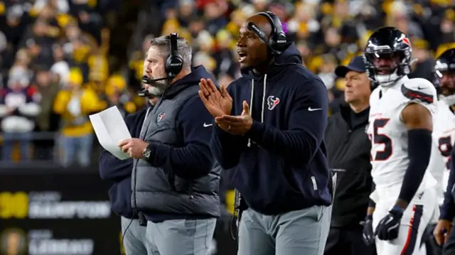 Houston Texans head coach DeMeco Ryans applauds during the play-off game against the Pittsburgh Steelers