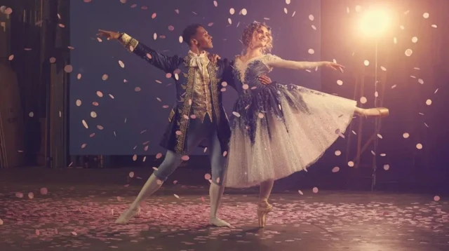 a male and female dancer on stage in Cinderella costumes