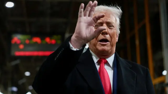 US President Trump gestures with his fingers while he visits the Ford production centre in Dearborn, Michigan.