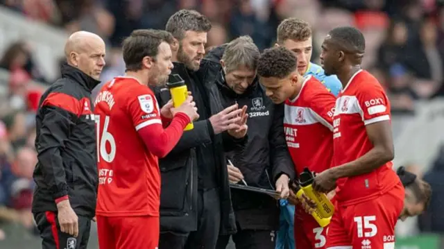 Michael Carrick surrounded by Middlesbrough players
