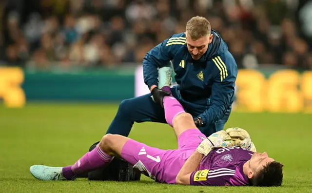 Newcastle United's English goalkeeper #01 Nick Pope receives treatment for an injury