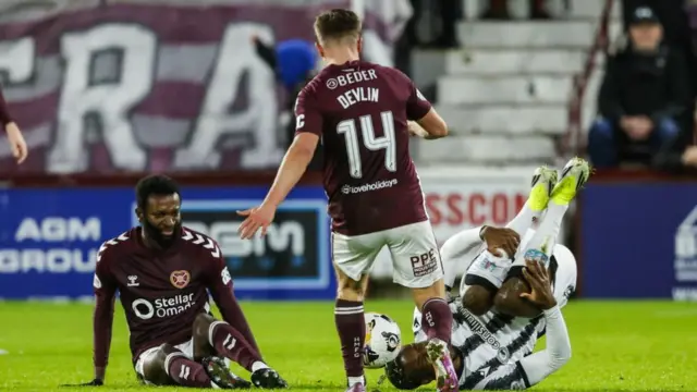 Hearts'  Beni Baningime (left) fouls St Mirren's Roland Idowu (right)