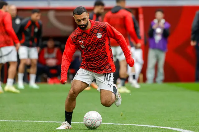 Salah warms up before the game against Senegal