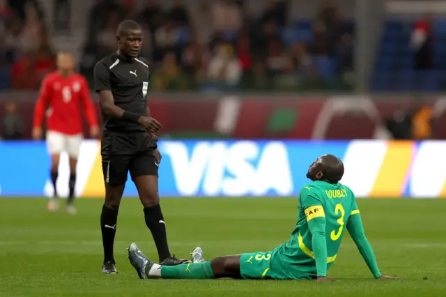 Senegal's Kalidou Koulibaly sits injured on the floor