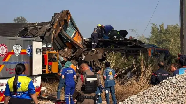 People crowding around a damaged train