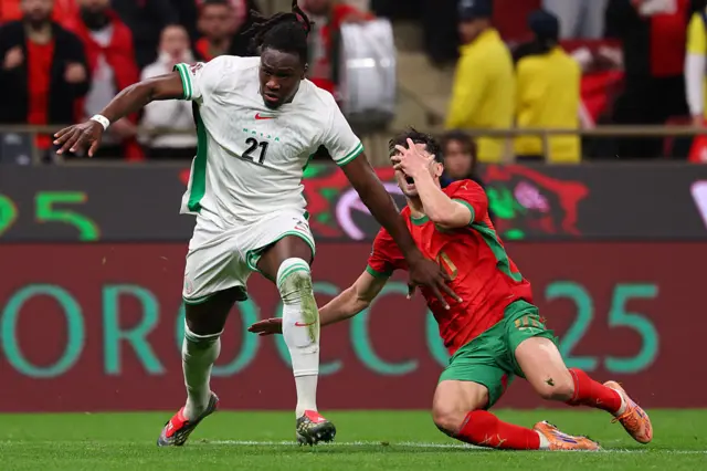 Bassey catches Diaz in the face with a flailing arm, causing him to fall to the floor