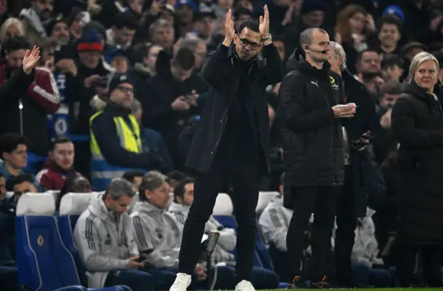 Chelsea manager Liam Rosenior applauds fans before the match