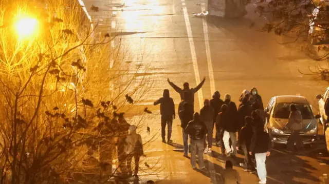 Protesters in the street at night in Tehran