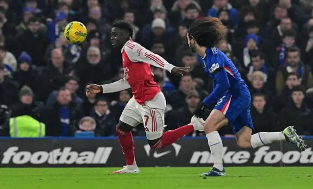 Chelsea's Spanish defender #03 Marc Cucurella (R) chases after Arsenal's English midfielder #07 Bukayo Saka