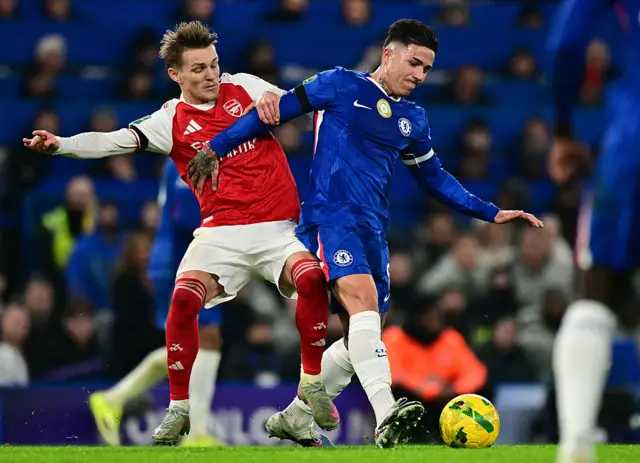 Arsenal's Norwegian midfielder #08 Martin Odegaard (L) vies with Chelsea's Argentinian midfielder #08 Enzo Fernandez
