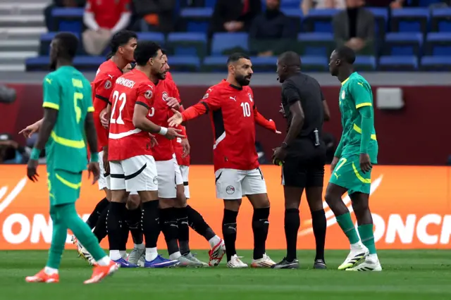 Egypt's Mohamed Salah remonstrates with referee Pierre Atcho