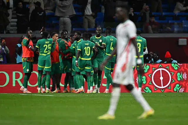 Senegal's players celebrate at the end of the Africa Cup of Nations (CAN) round of 16 football