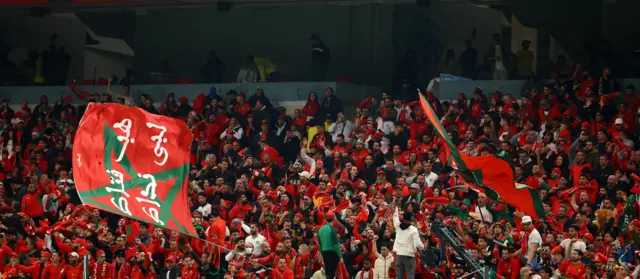 Morocco fans wave flags inside the stadium