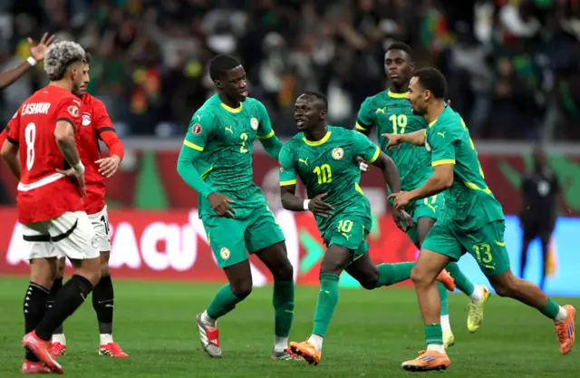 Mane runs to celebrate his goal with teammates