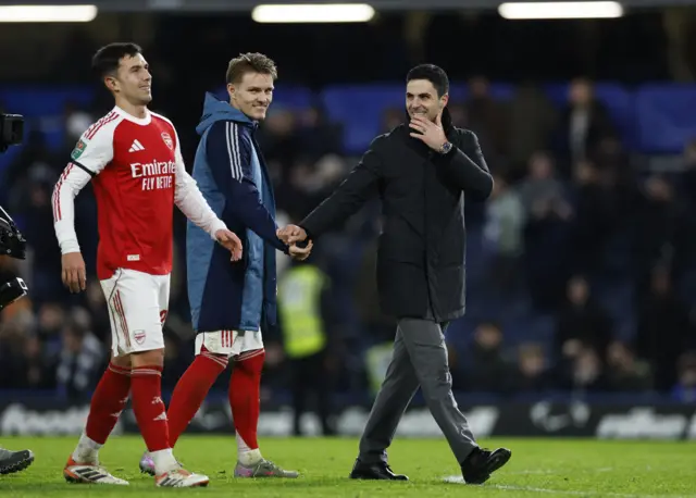 Arsenal's Martin Zubimendi, Martin Odegaard and manager Mikel Arteta celebrate