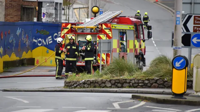 Firefighters are seen in the street in Plymouth.