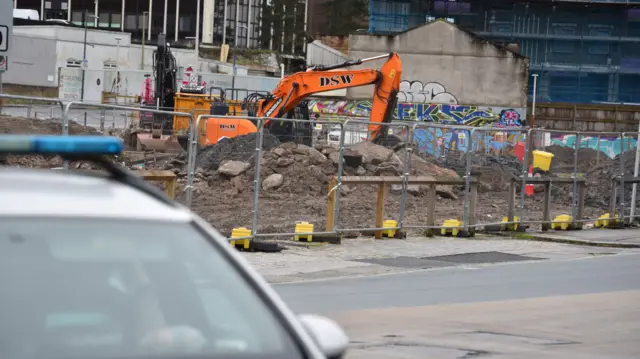 An excavator in a car park