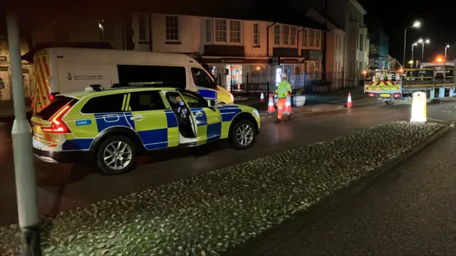 Police moving a cordon in Exmouth.