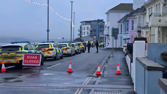 Police cars lining the street on Exmouth seafront.