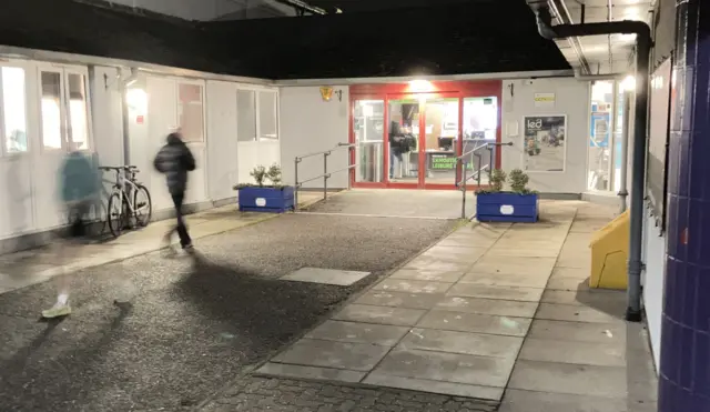 People arriving at a leisure centre.