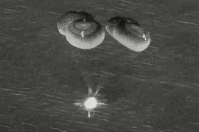 Parachutes release from the Dragon Endeavour as it approaches the Pacific Ocean