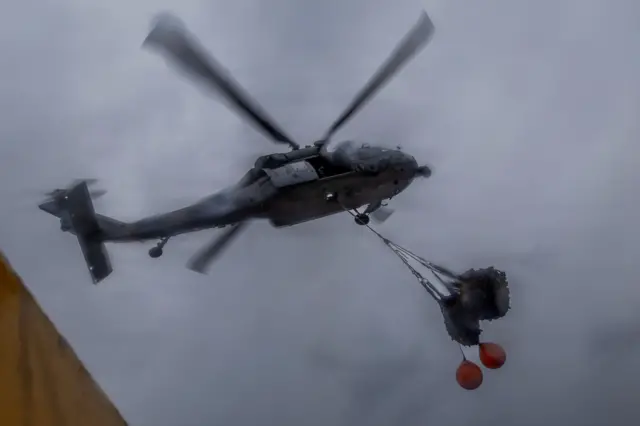 A helicopter with cargo slung under its fuselage - picture from the USS Abraham Lincoln Facebook page