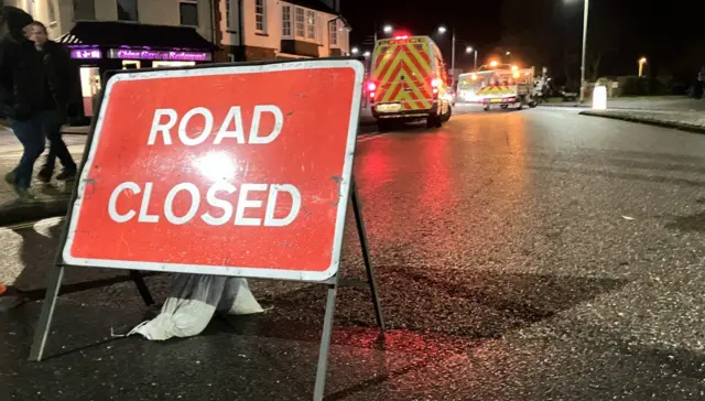 Road closed sign on road