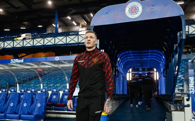 Player-manager Wullie Gibson walks out of the Ibrox tunnel