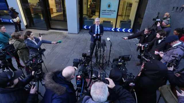 Aerial view of Simon Foster in front of media