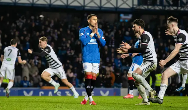 Queen's Park players celebrate after James Tavernier's penalty miss