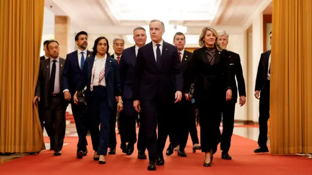 Carney walks in with his team