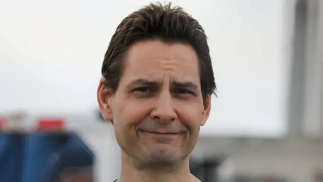 Michael Kovrig smiling at the camera