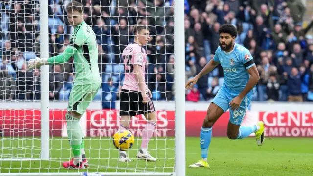 Ellis Simms watches as his deflection crosses the line