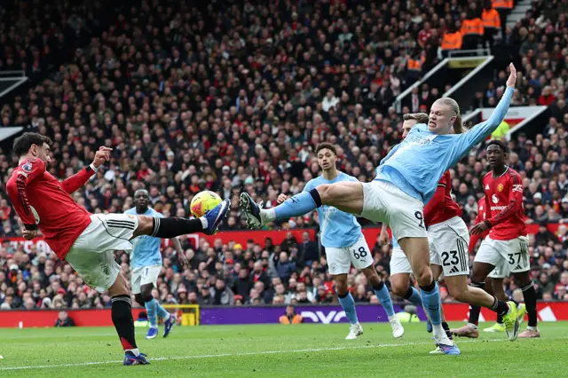 Manchester United's Portuguese midfielder #08 Bruno Fernandes (L) vies with Manchester City's Norwegian striker #09 Erling Haaland