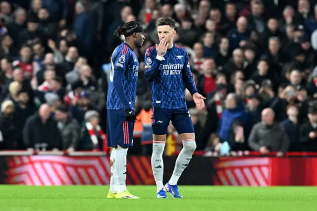 Ben White of Arsenal speaks with teammate Noni Madueke