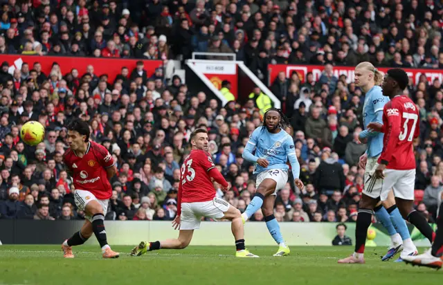 Antoine Semenyo of Manchester City shoots past Luke Shaw
