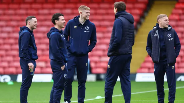 Millwall players inspect the pitch at Vicarage Road