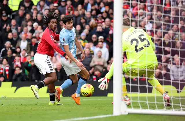 Patrick Dorgu of Manchester United has a shot saved by Gianluigi Donnarumma