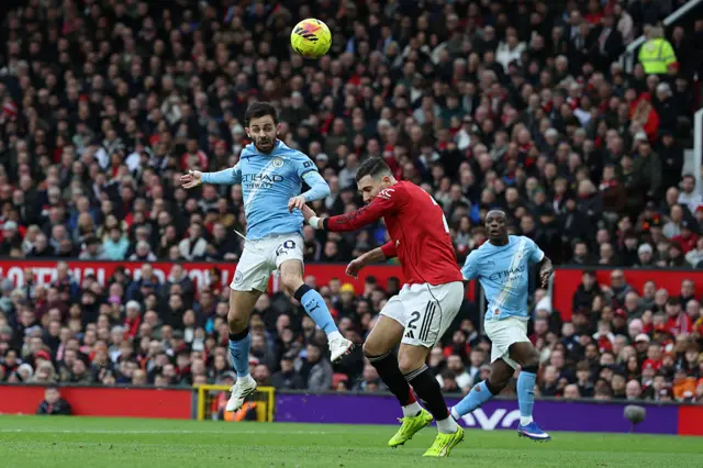 Manchester City's Portuguese midfielder #20 Bernardo Silva heads over