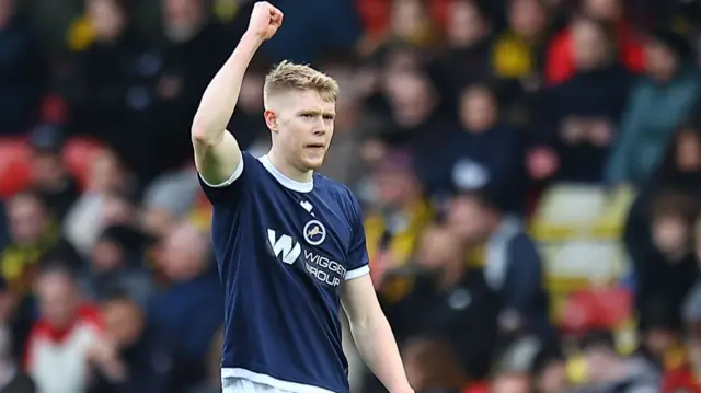 Millwall goalscorer Josh Coburn raises a fist in celebration