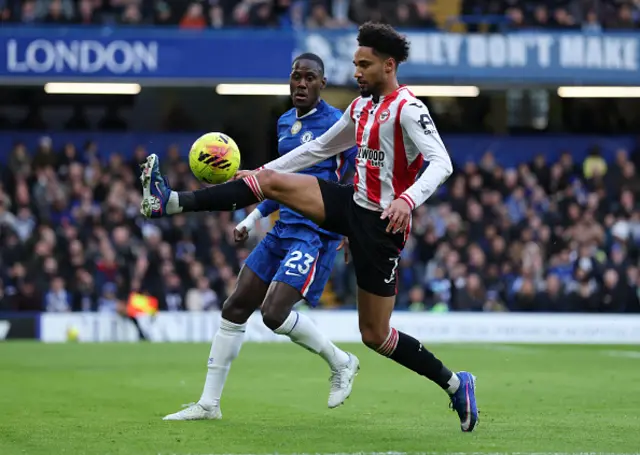 Kevin Schade of Brentford is put under pressure by Trevoh Chalobah