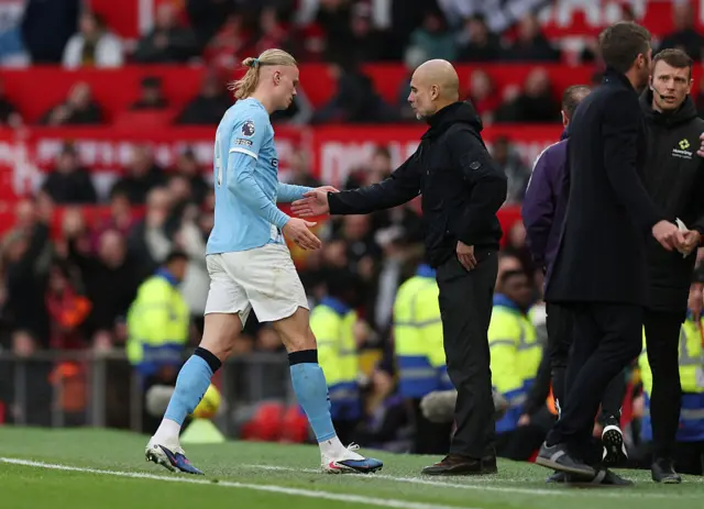 Pep Guardiola embraces Erling Haaland of Manchester City