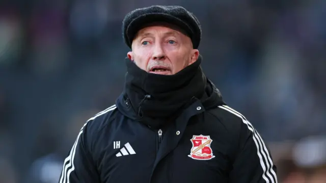 Ian Holloway in a flat cap and snood